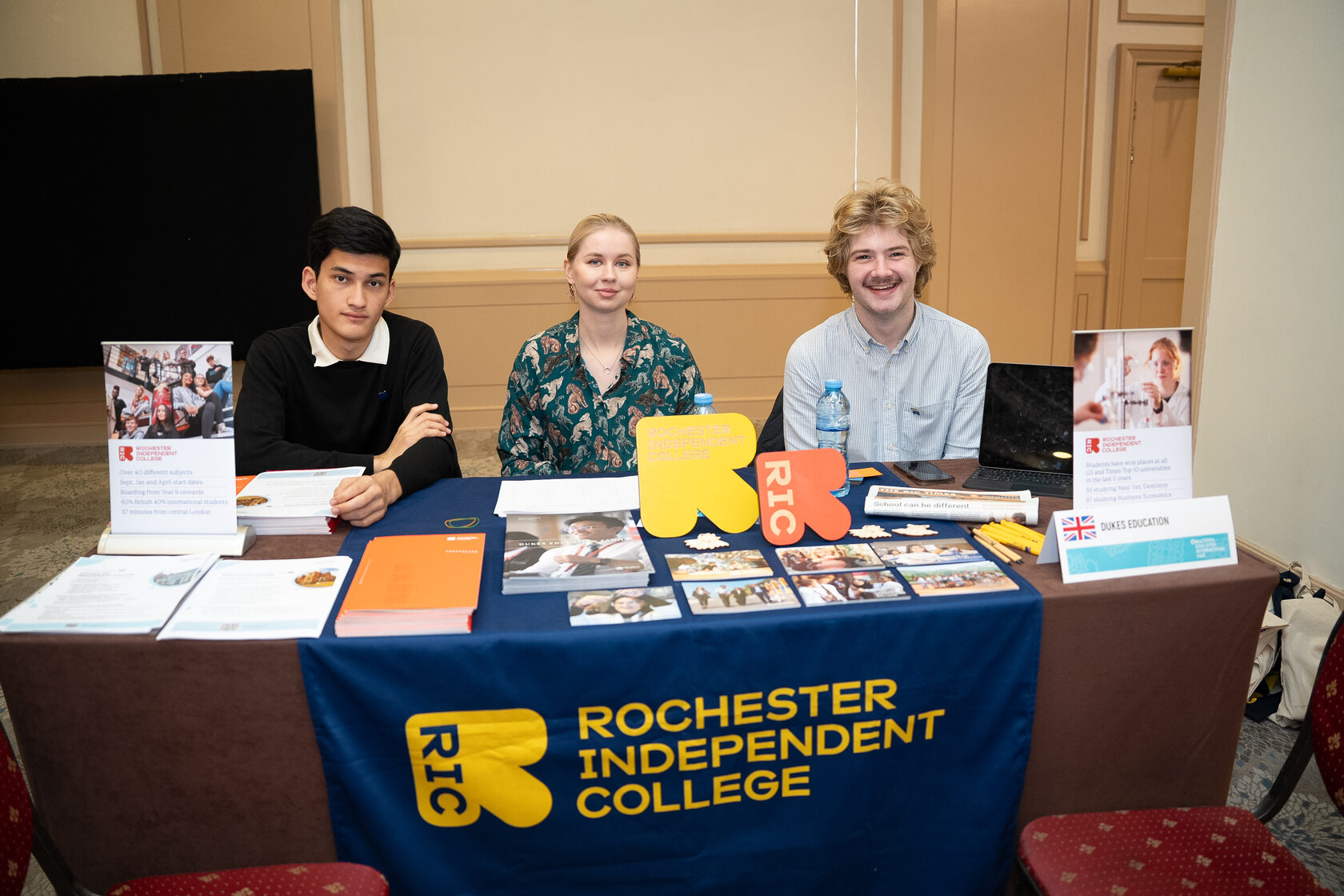An exhibitor advising a prospective student