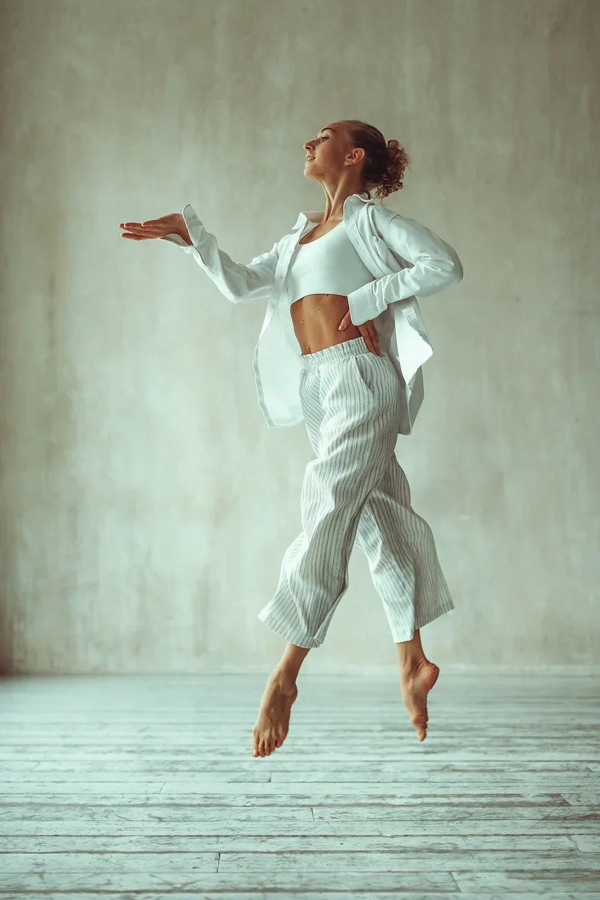 Anna Peshkova, founder of DANNCE HUB, captured mid-jump in a studio