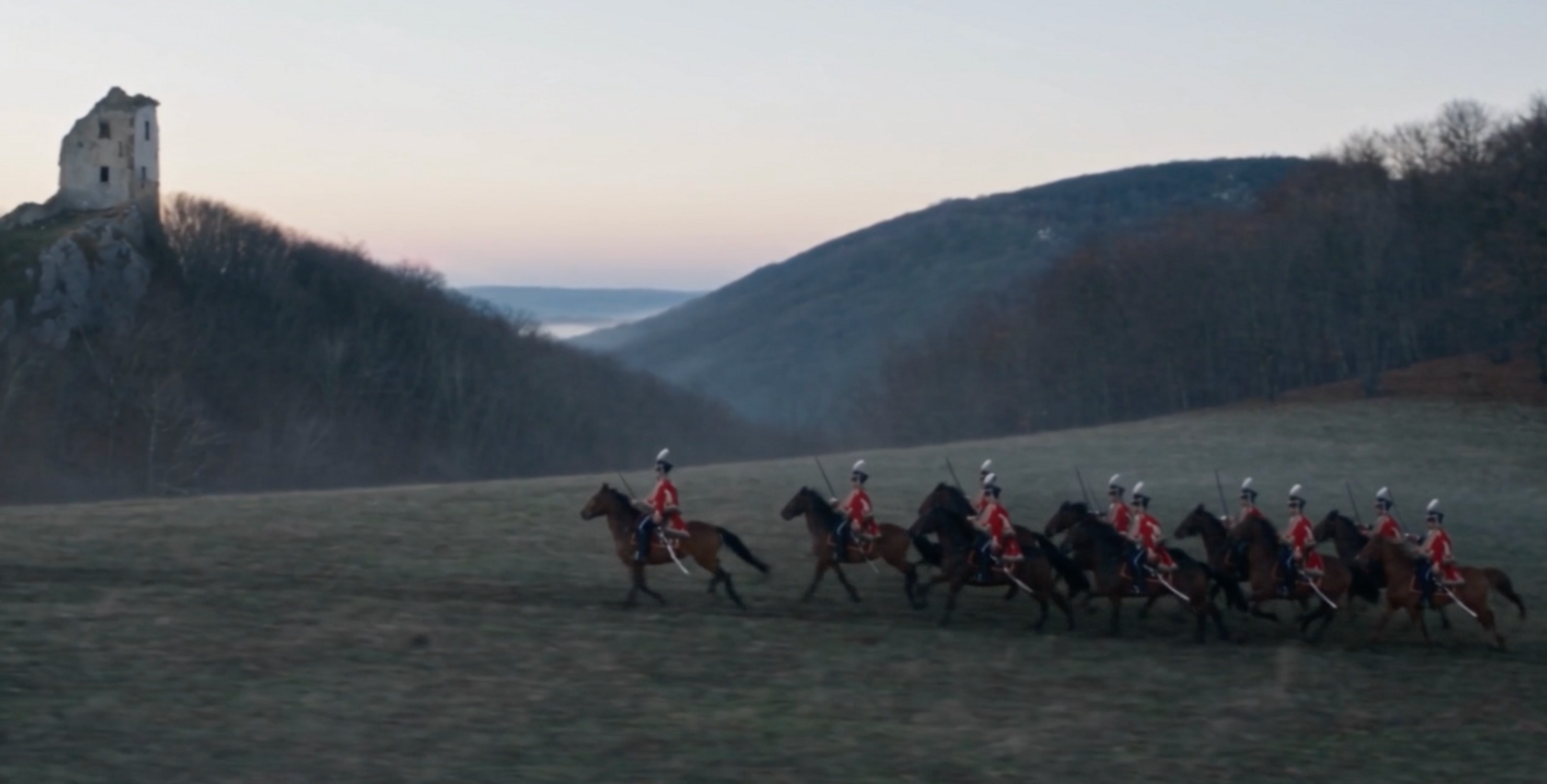 A still from an AI film by the studio: riders against hills and castle ruins