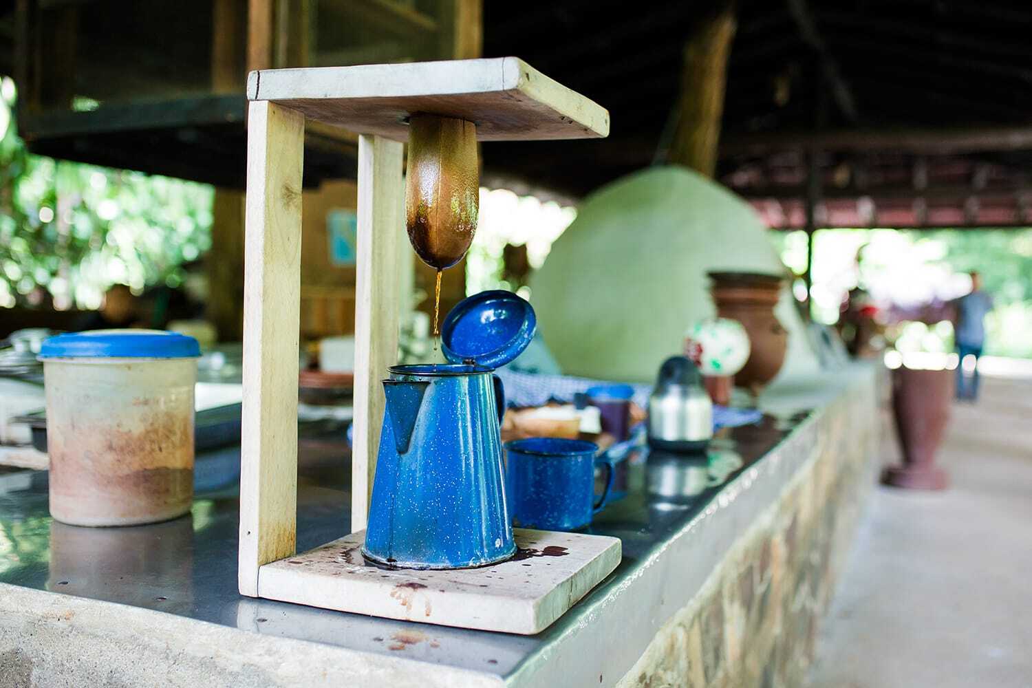 Traditional cloth coffee filter above a blue enamel coffee pot