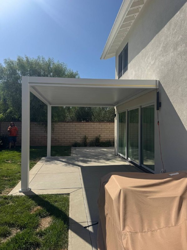 Closed louvered aluminum patio cover attached to Huntington Beach home