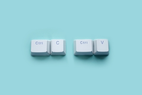 Isolated keyboard keys of control c control v on a blue background