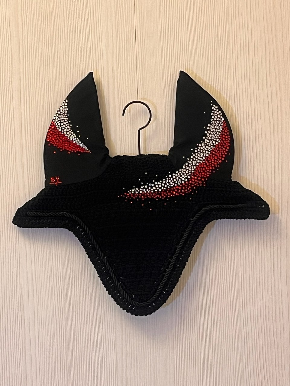 Black wholesale horse ear net with a red and white pattern.