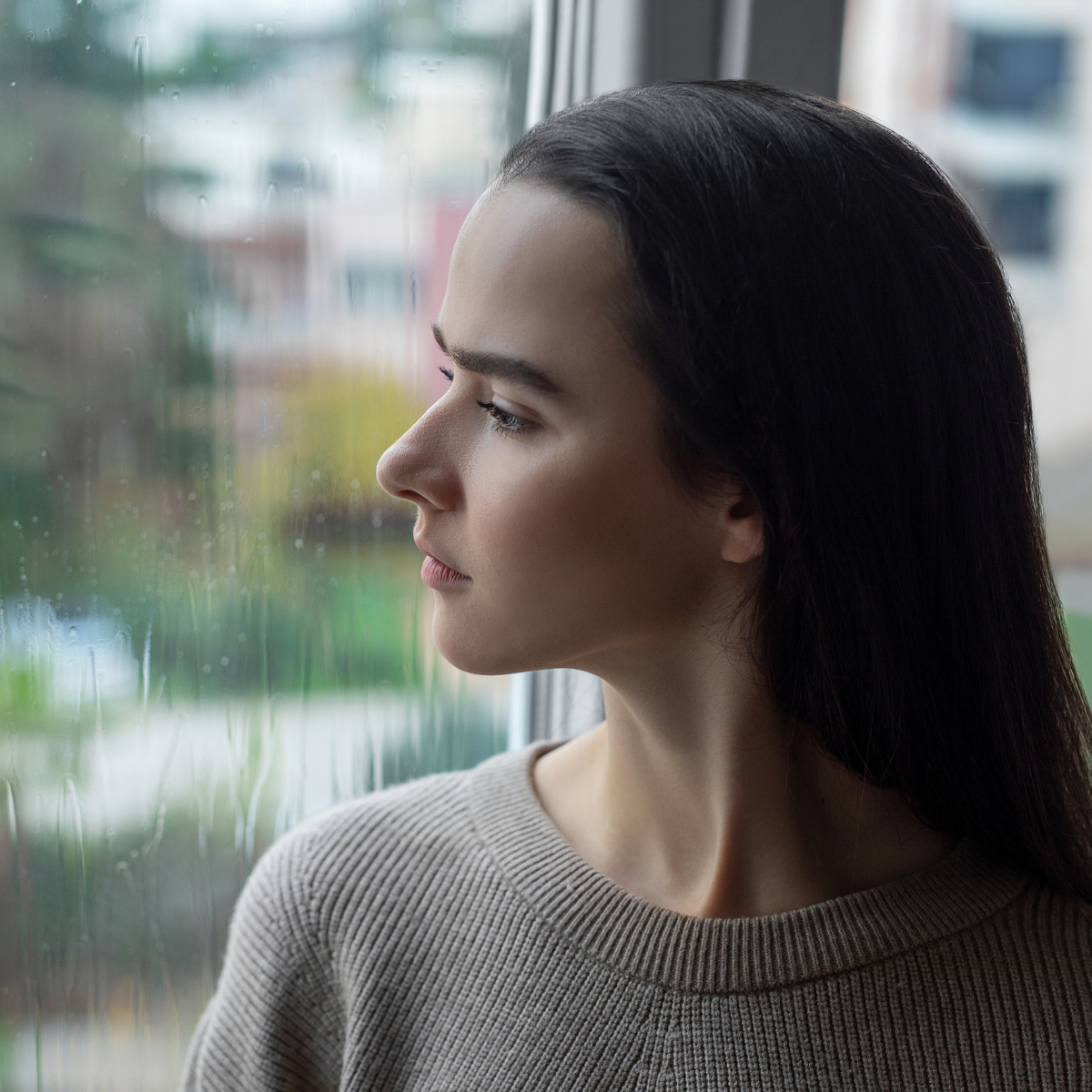 Girl looking out a window - negative self-talk