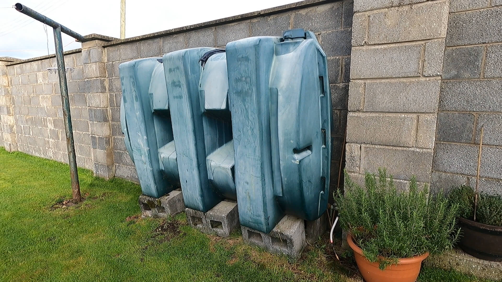 Homeowner taking photos of old domestic oil tank before replacement quote