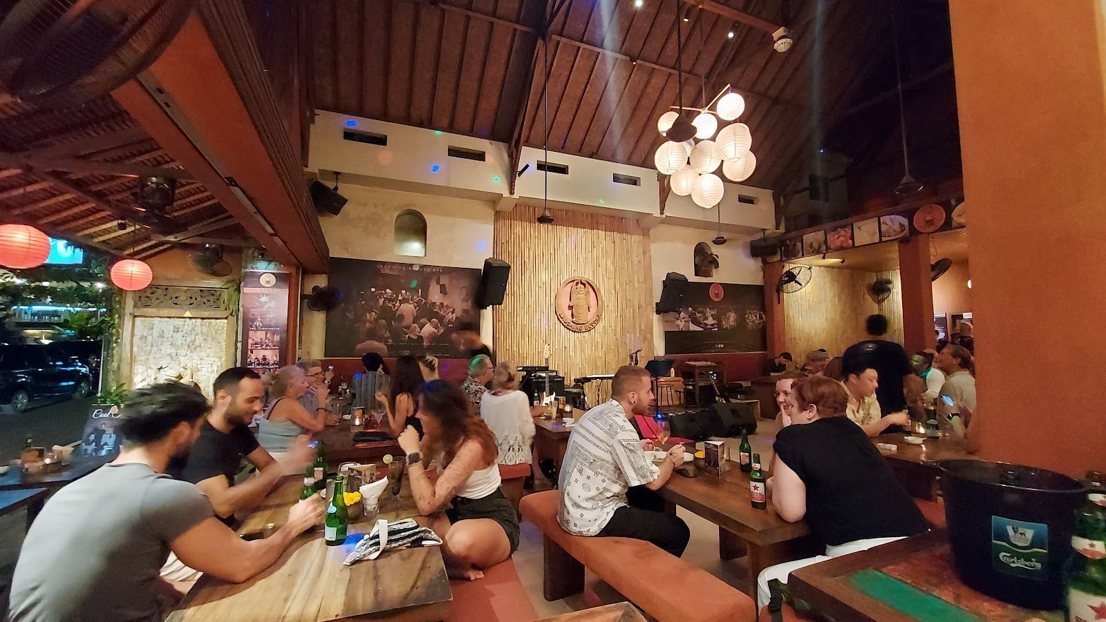 A lively crowd enjoying drinks and live music at Laughing Buddha Bar, a staple on Monkey Forest Road and easily one of the best bars in Bali for a fun, high-energy night out.