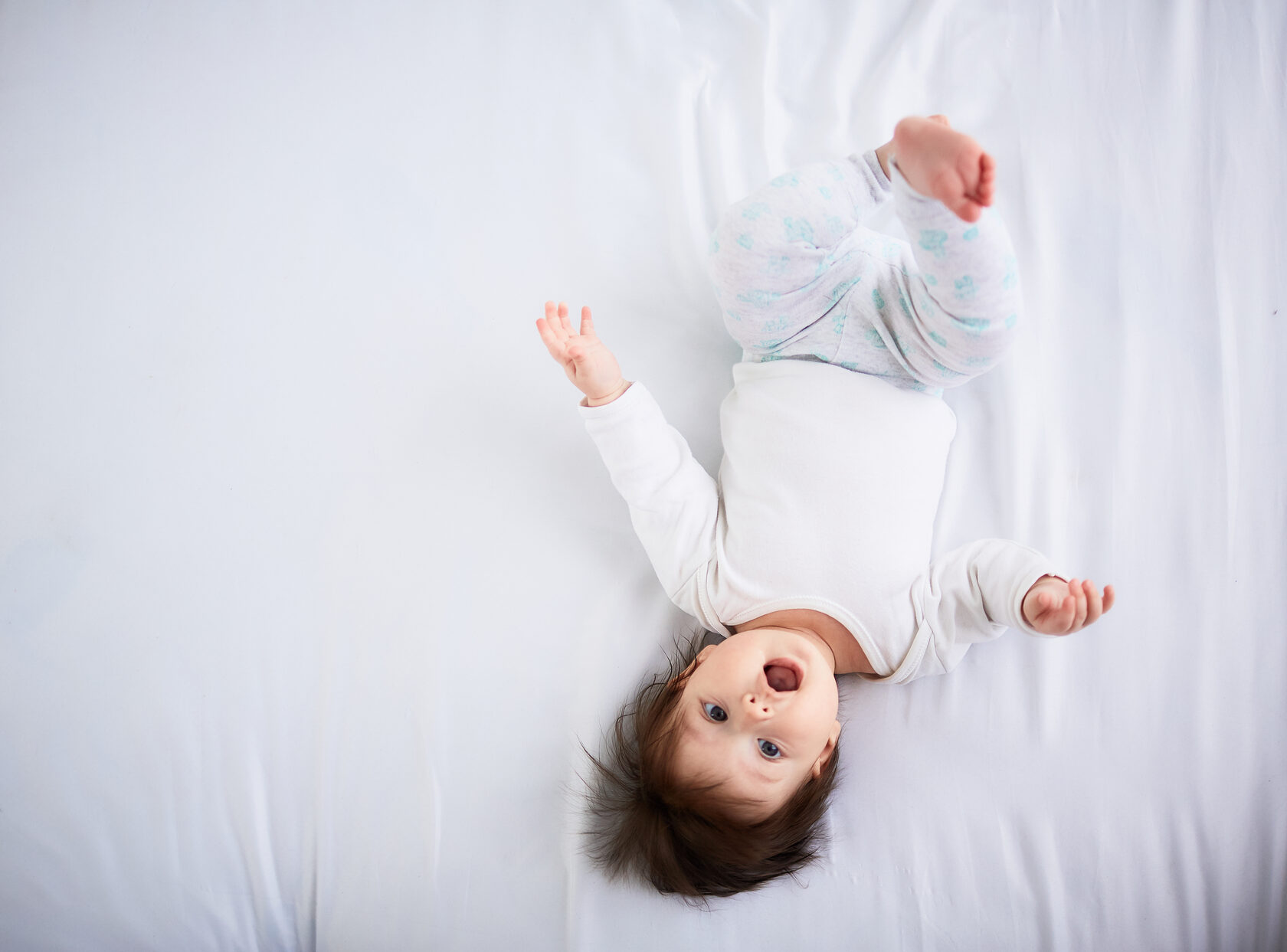 Baby awake at night, experiencing sleep disruption common during growth spurts and regressions.