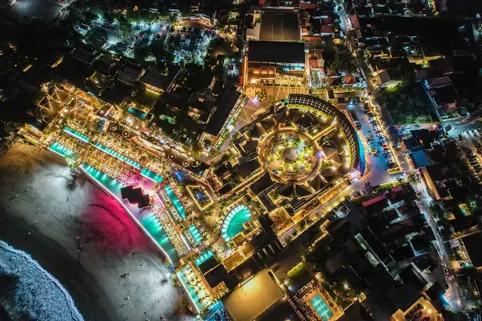 An impressive nighttime aerial shot of the massive Atlas Beach Fest complex, showcasing the sheer scale of one of the biggest and best bars in Bali.