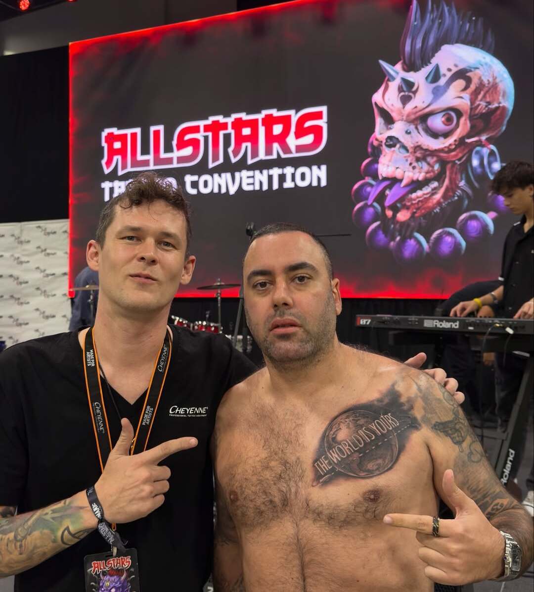 Tattoo artist Rinat Mingazdinov with musicians from the band Centr SLIMUS at a tattoo convention