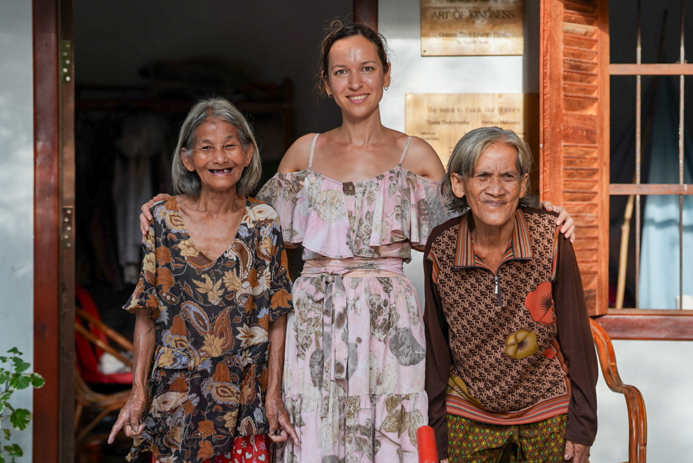 An elderly Cambodian grandmother with a warm, knowing smile