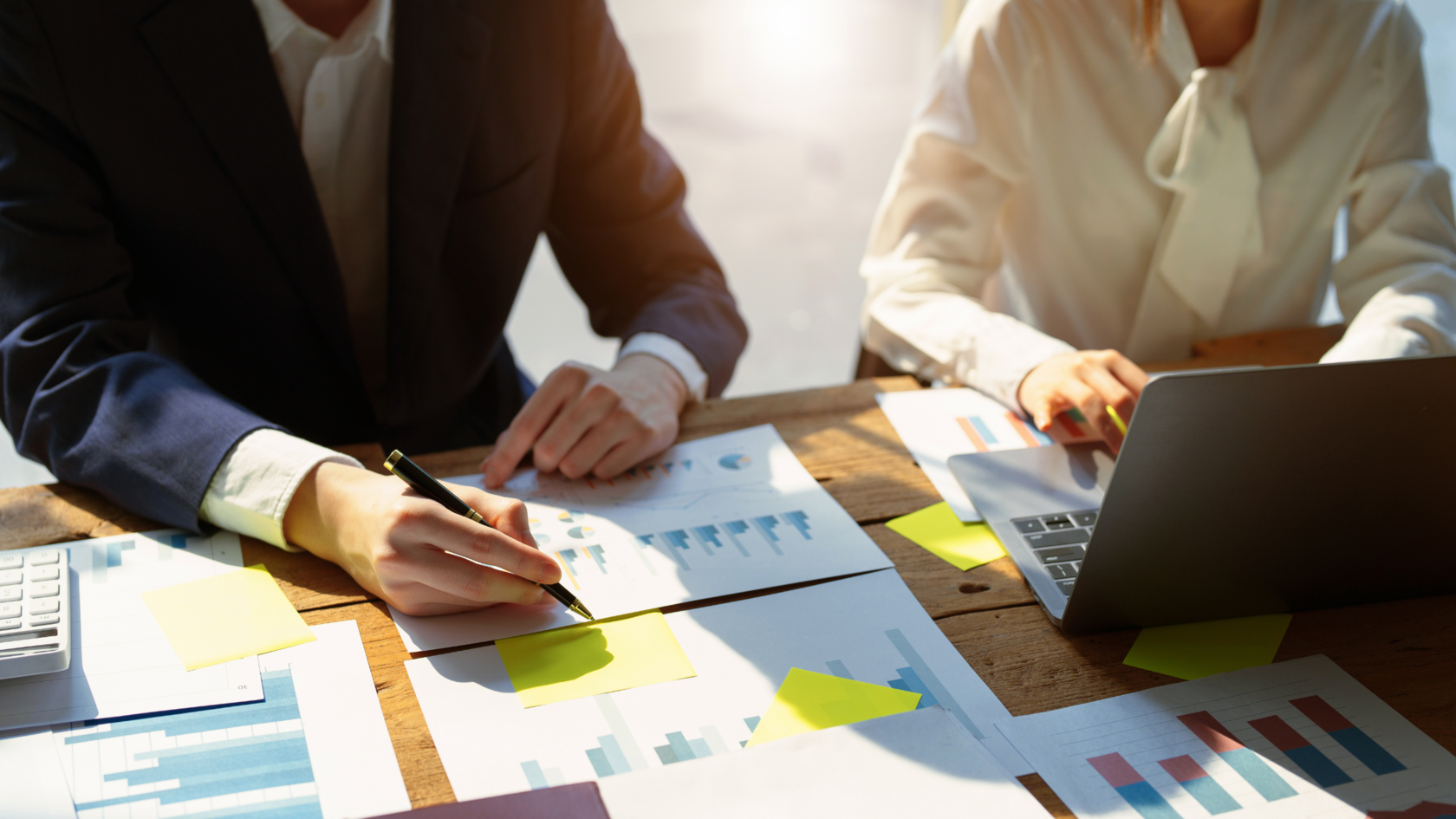 Business professionals collaborating on a debt raising strategy.