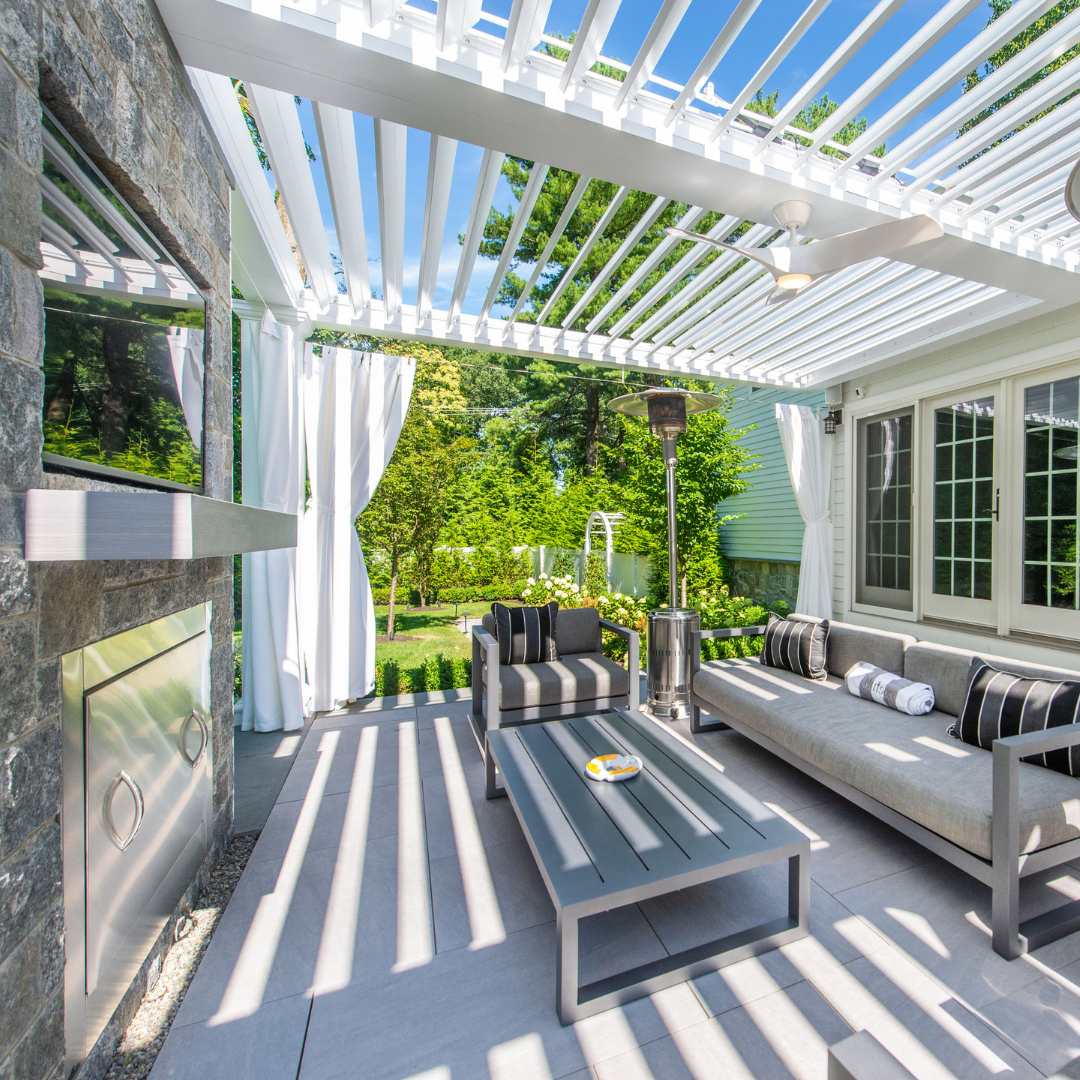 Outdoor entertainment area under an aluminum motorized louvered pergola