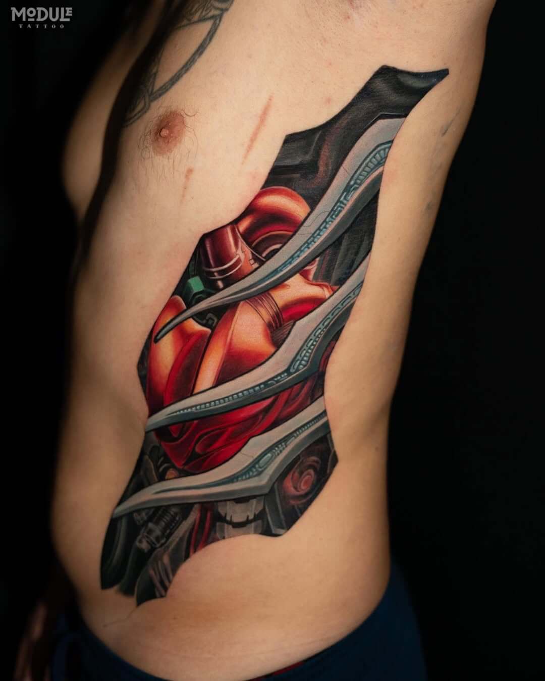 Biomechanical tattoo on the side, cyborg heart, effect as if from under the skin, Los Angeles, West Hollywood
