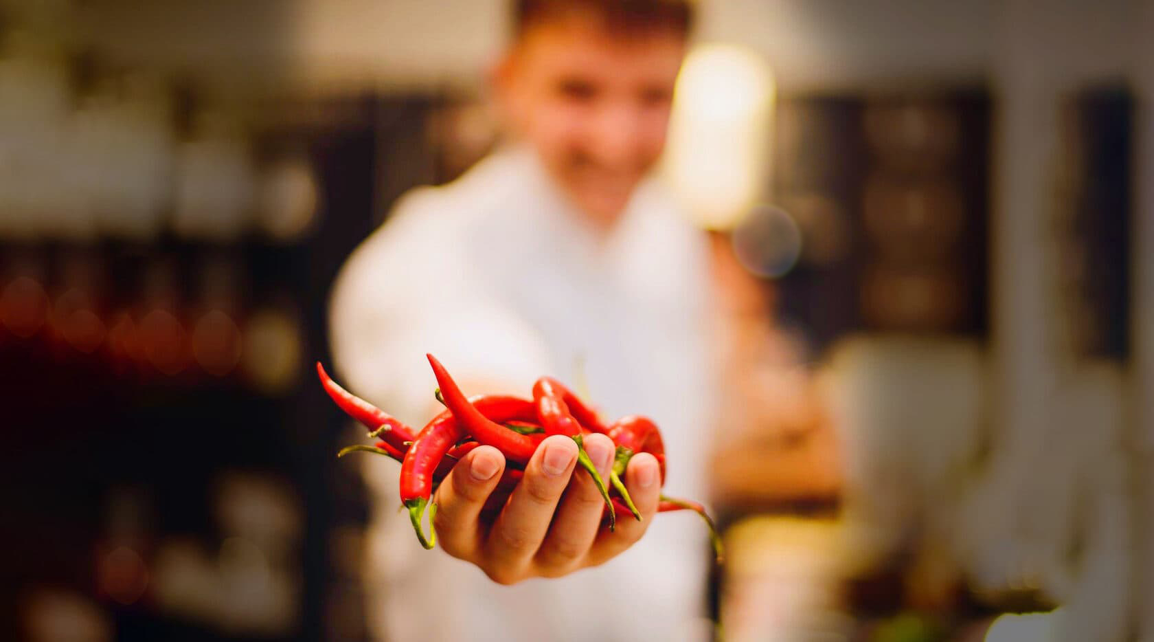 private chef in Mexico holding fresh chili peppers