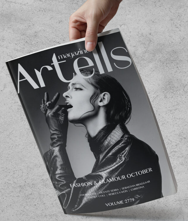 Creator holding an Artells Magazine print edition for a community feature