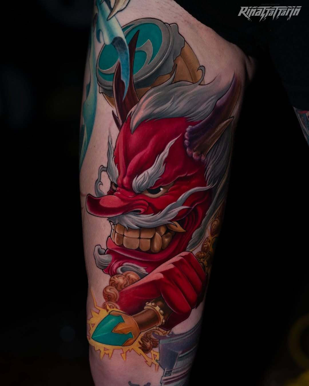 Detailed red Japanese demon mask (Oni) tattoo with white hair and gold accents, completed in 2 sessions, by Rinat Mingazdinov, Los Angeles