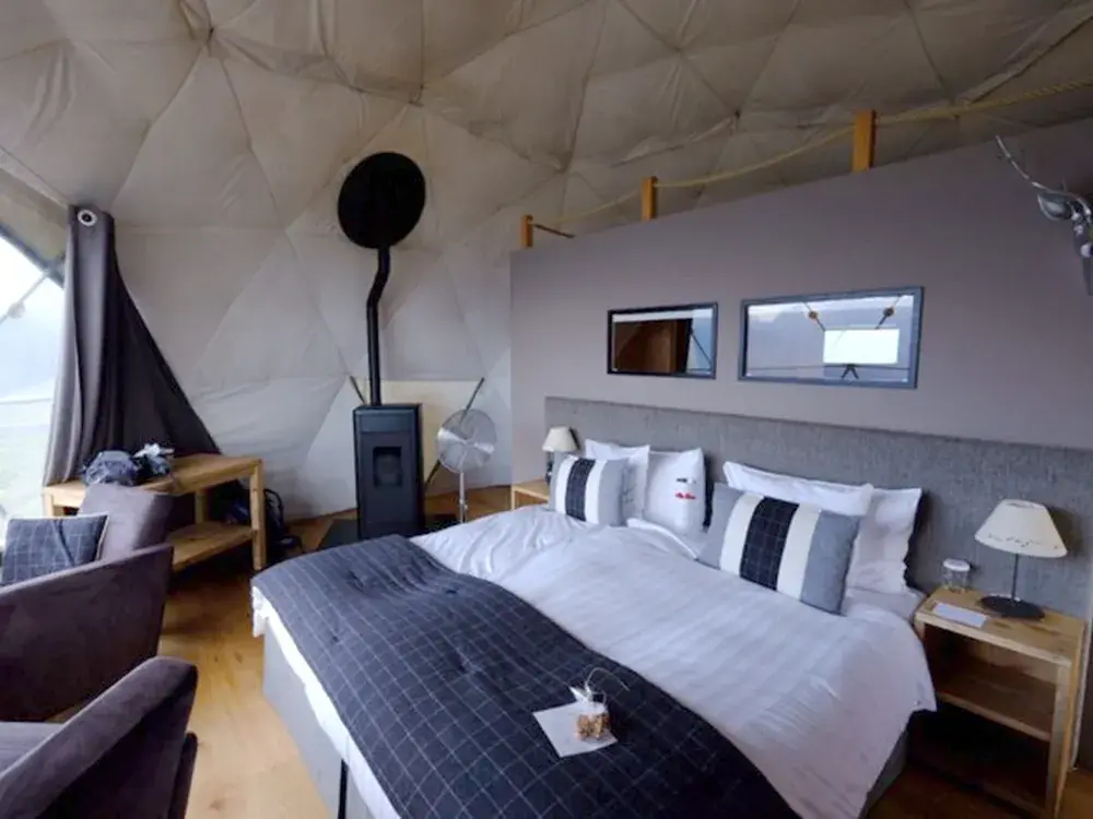 Глэмпинг-номер: кровать, печь, панорамное окно