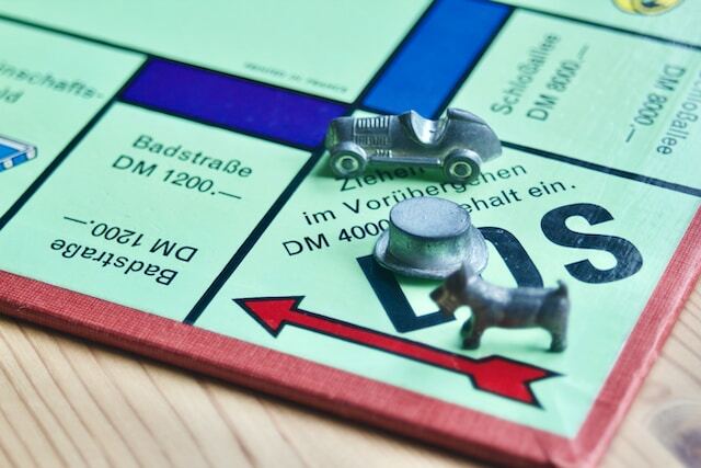 Monopoly game board with a car and cat chips