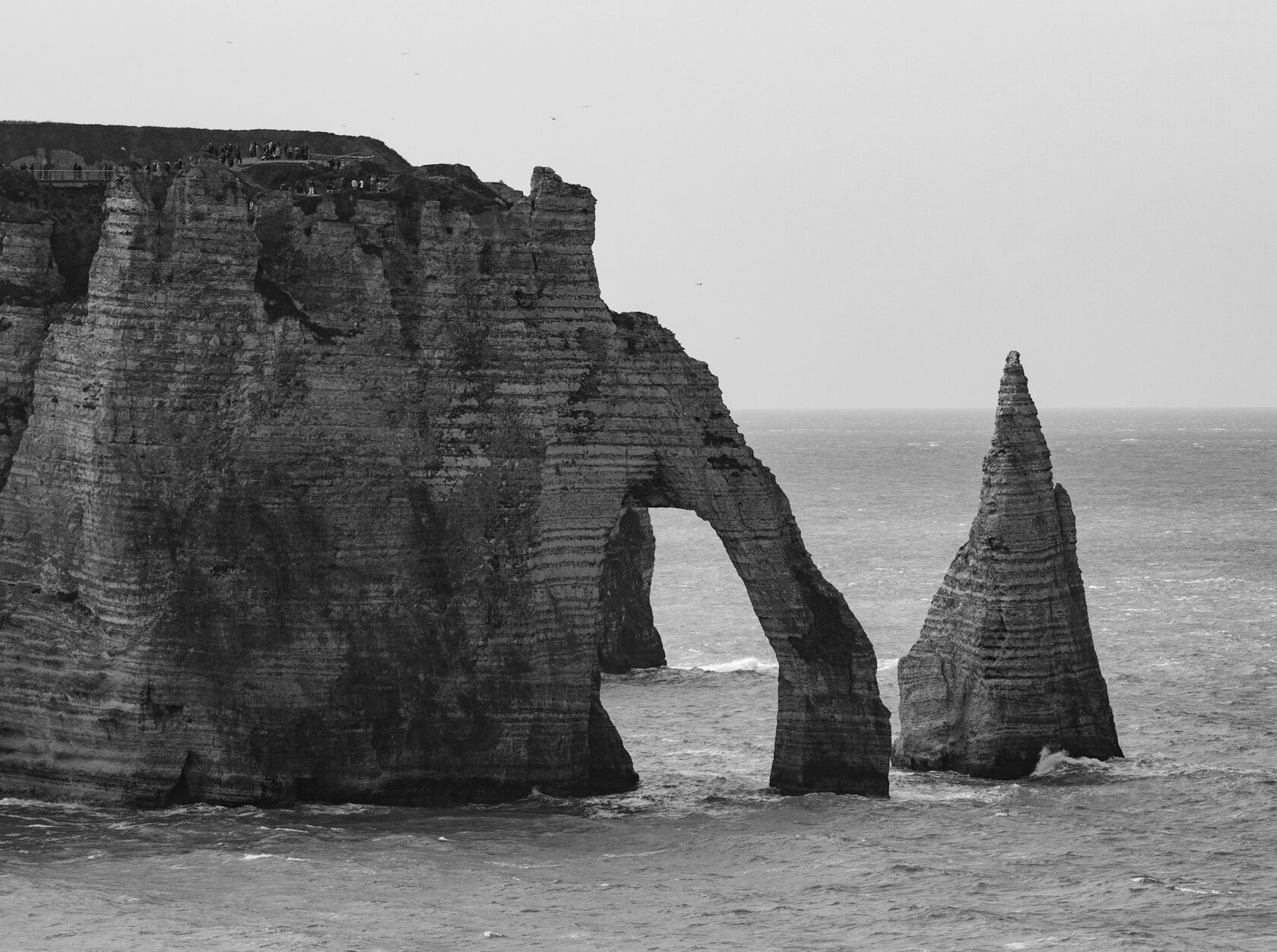 White chalk cliffs of Étretat meeting the sea on the Normandy coast