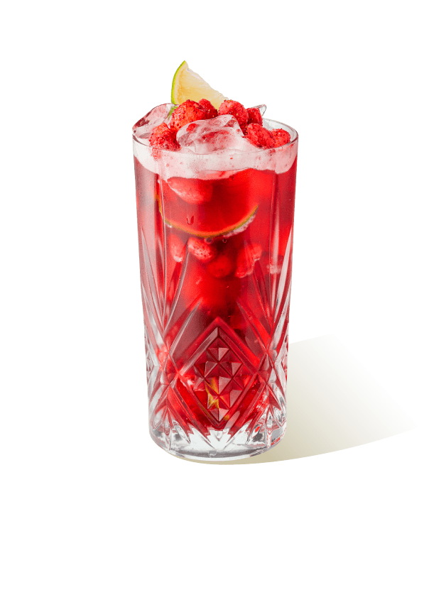 Berry iced tea served in a tall glass with ice, lime slice, and red fruit topping, made using The Base Beverage iced tea powder