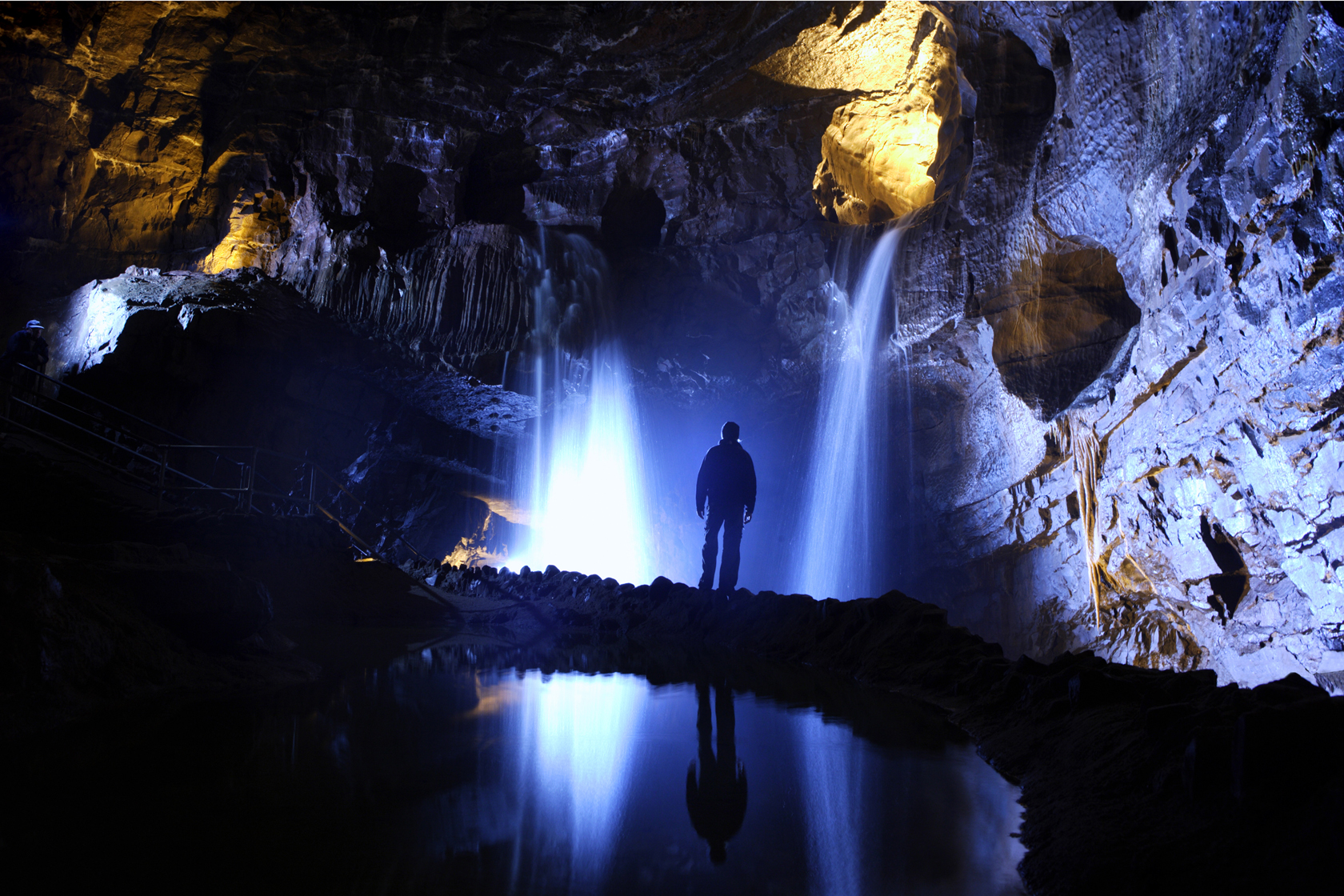 Man and lights in Dan Yr Ogof caves