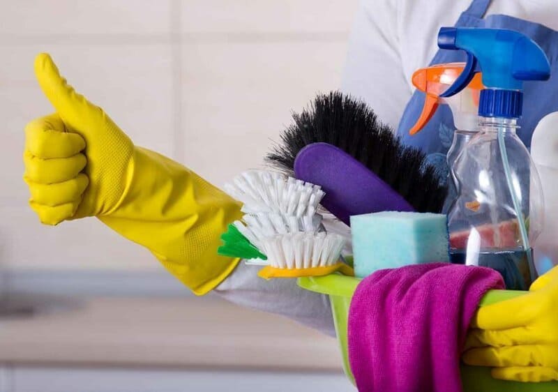 woman holding cleaning products
