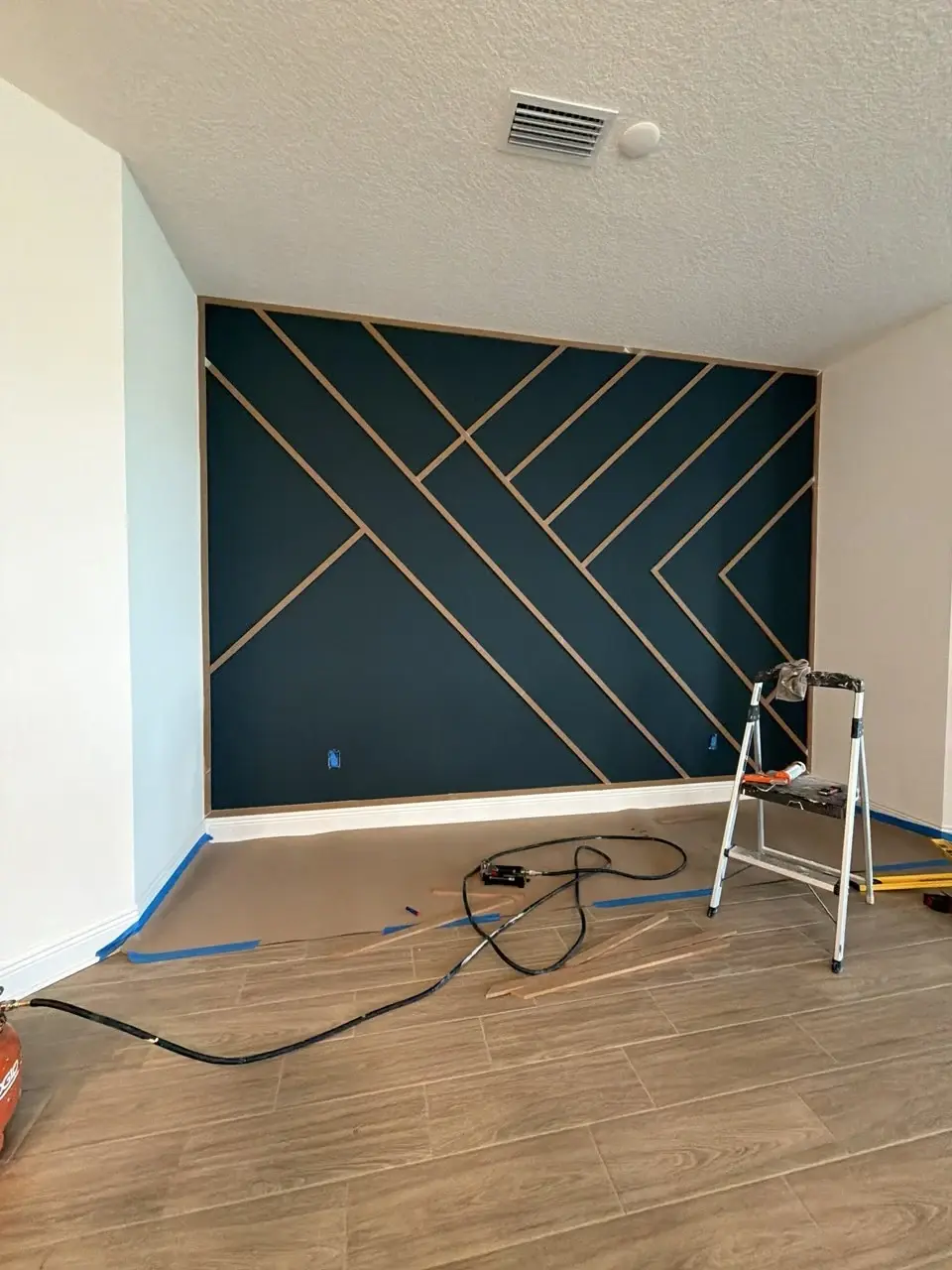 Geometric trim layout during board and batten accent wall installation in Bradenton