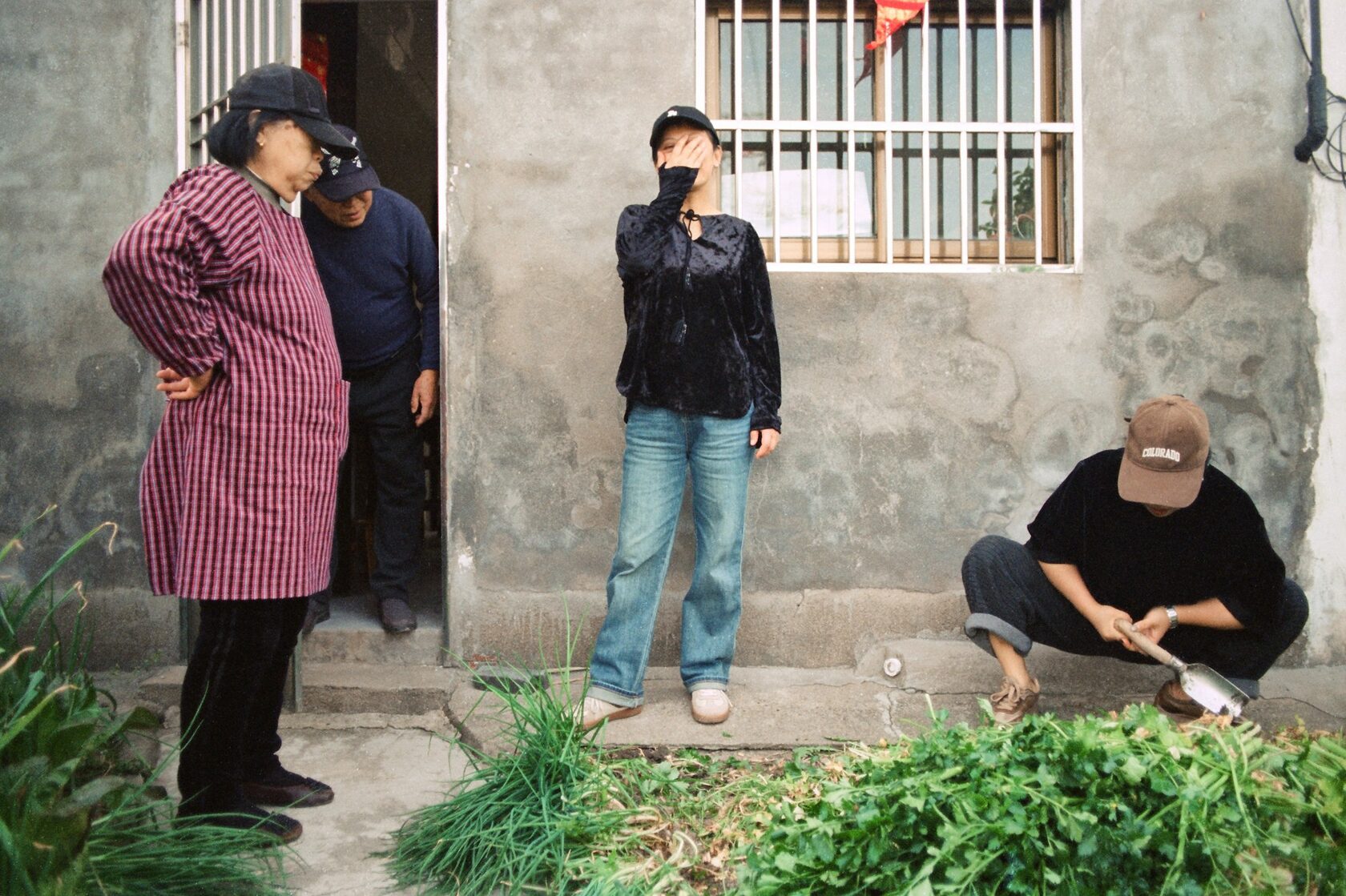An elderly woman tending a garden