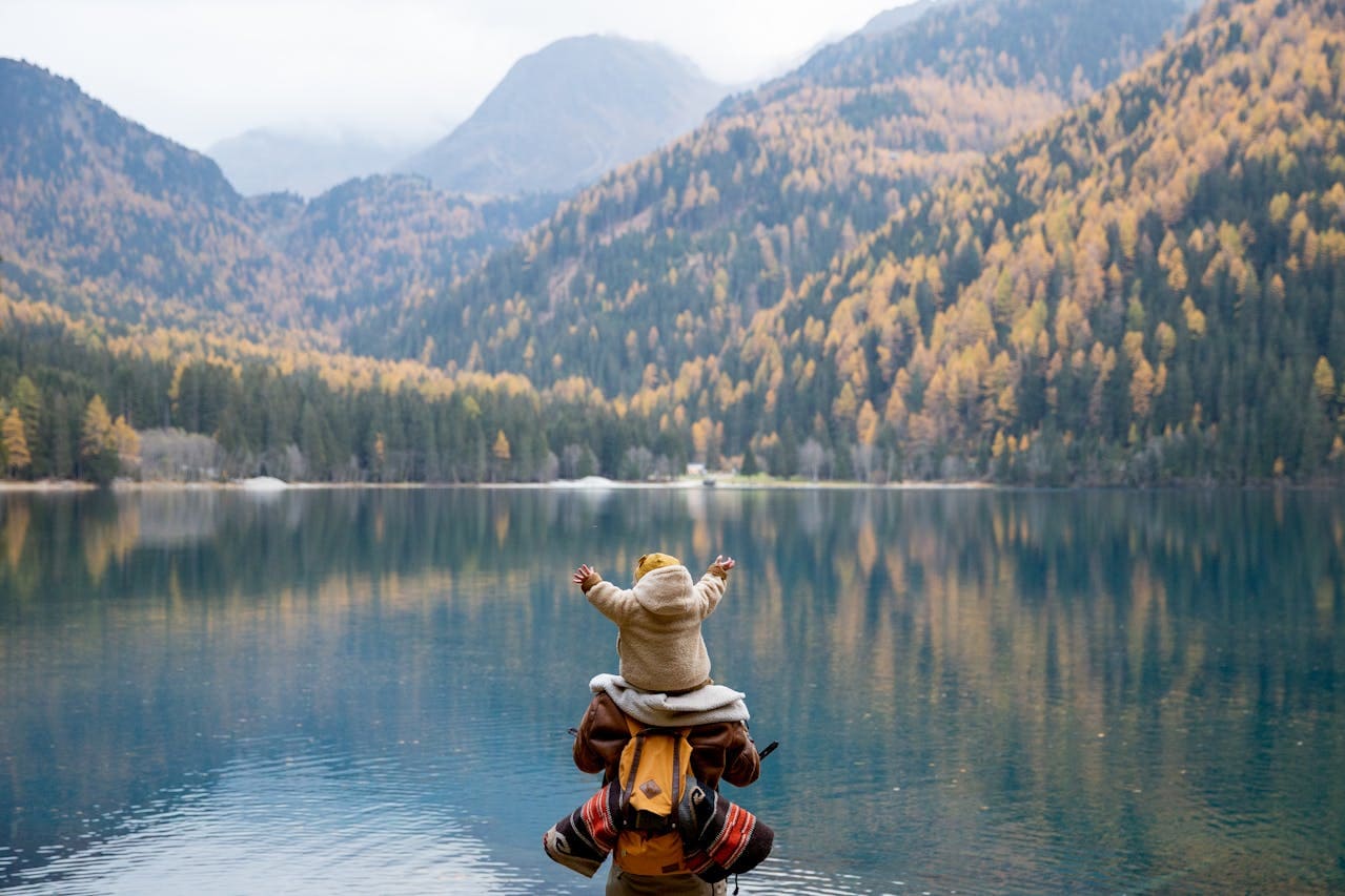Family by lake with mountains for group visa applications in Dubai 10% off by Slotby's