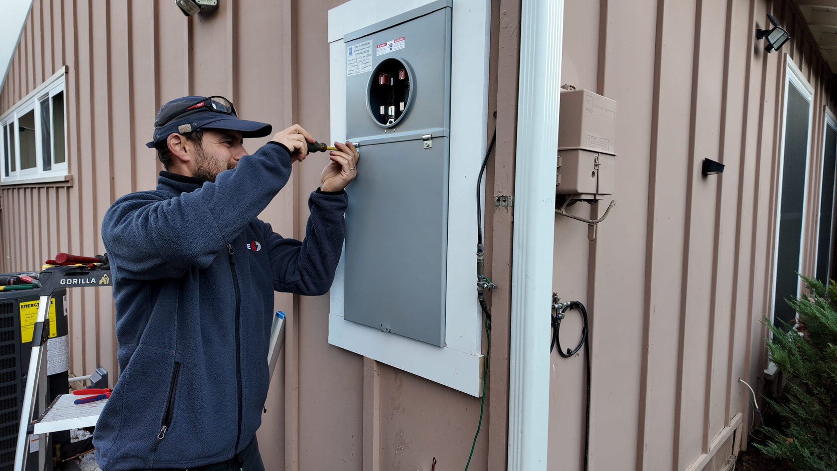 An electrician doing their job according to a kitchen wiring guide