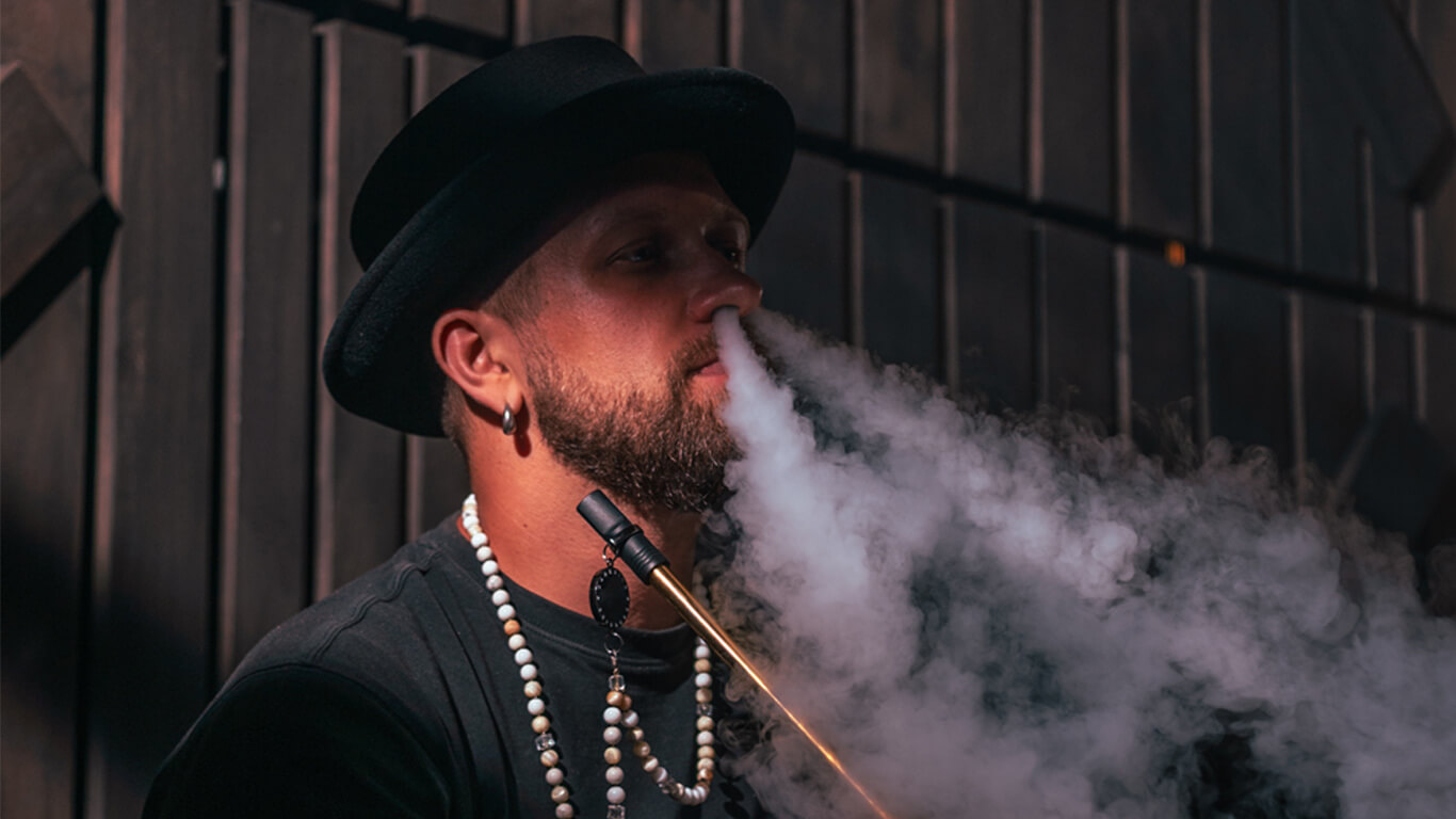 a man enjoying hookah in a lounge.