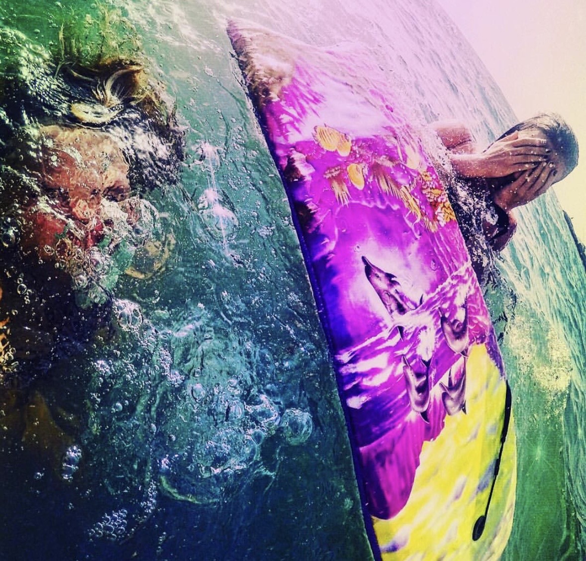Tidal Meridian — a surfer submerged beneath green water, surfboard catching prismatic light