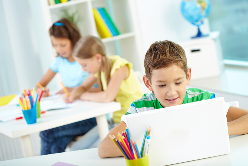 A young student learning using a computer