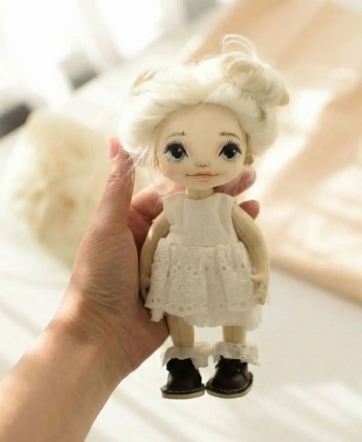 Hands holding doll