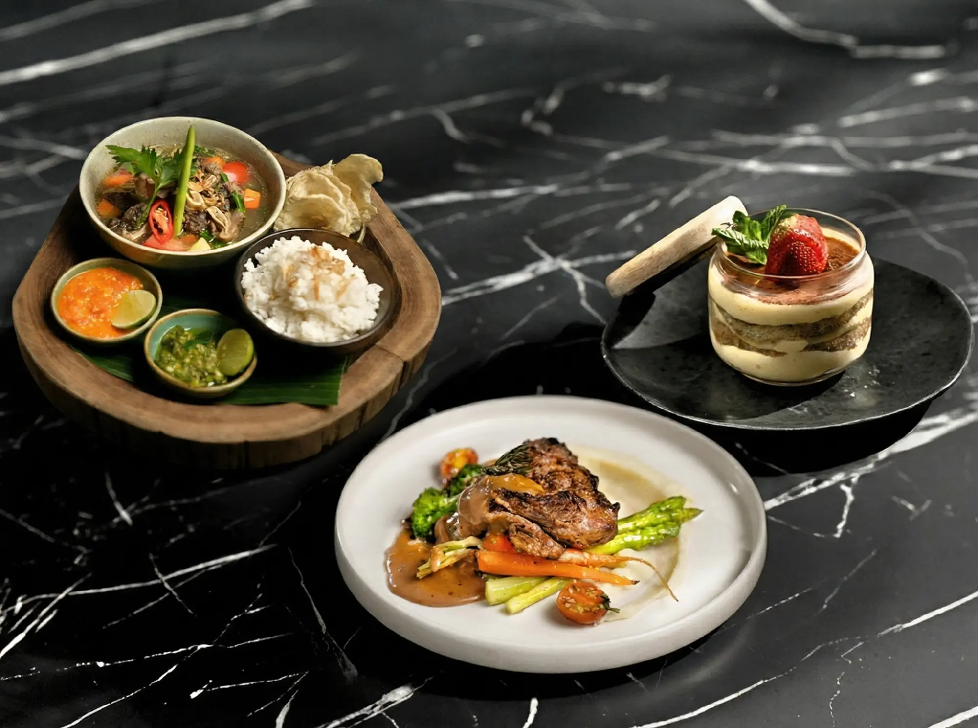 An indulgent spread for a halal iftar in Bali featuring the 'Treat Yourself' combo at Eden Lounge, complete with warm Sop Buntut, a juicy beef steak, and a tiramisu cup for dessert