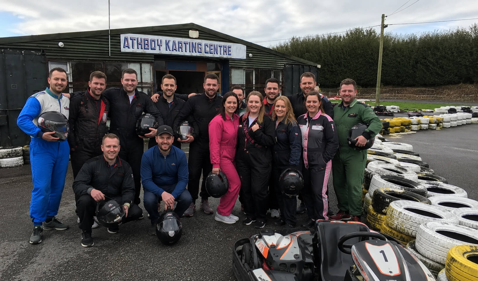 Stag and hen group holding helmets before outdoor karting at Athboy Karting Centre in Co. Meath
