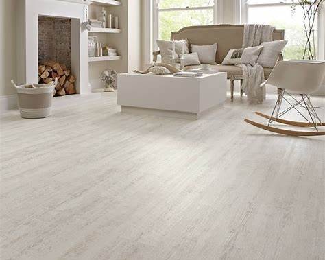 Laminate flooring and vinyl plank flooring shown in modern living room interiors for comparison.