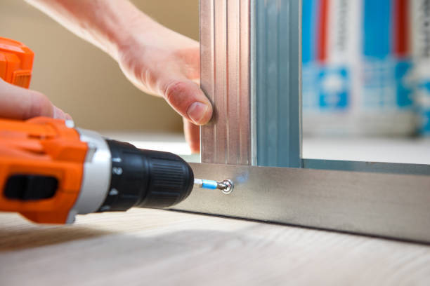 a man fastens a profile with a screwdriver. Do it yourself a man fastens a profile with a screwdriver. Do it yourself drywall Repairs Handyman Services stock pictures, royalty-free photos & images