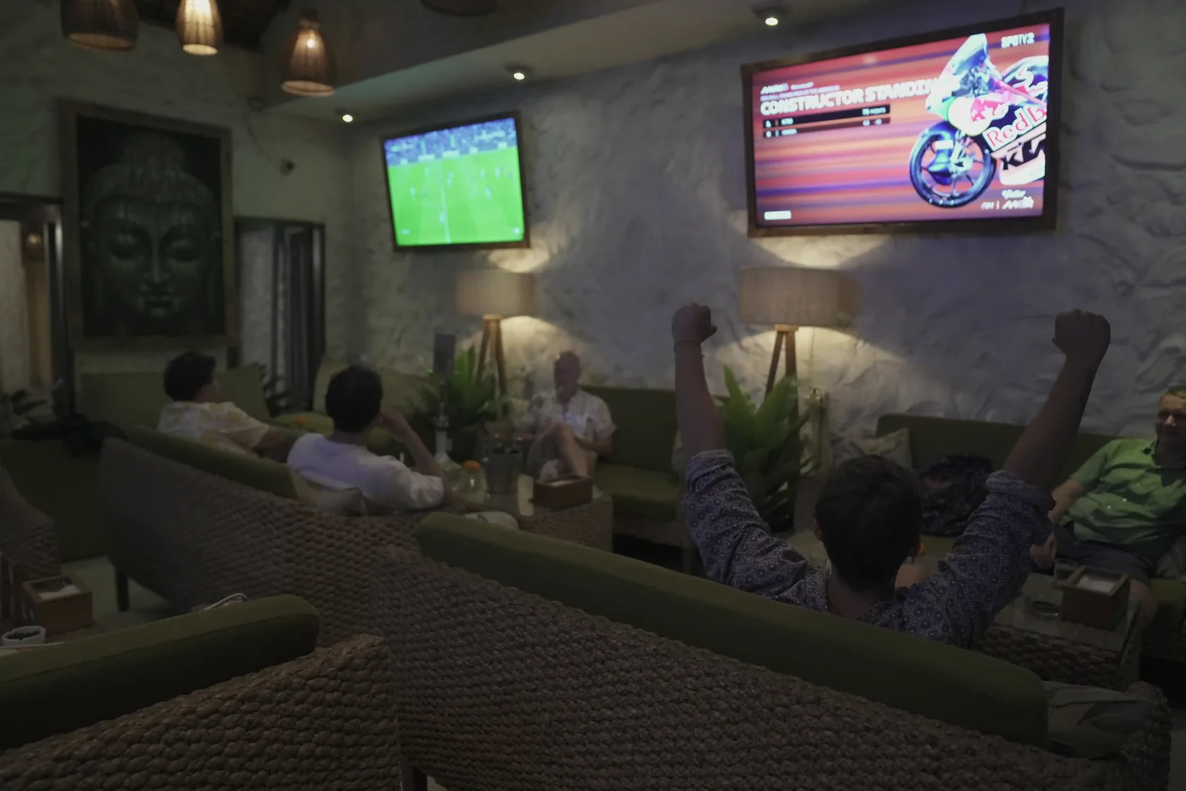 xcited fans cheering while watching live sports on large screens at Eden Sport Lounge, the perfect venue for football viewing parties