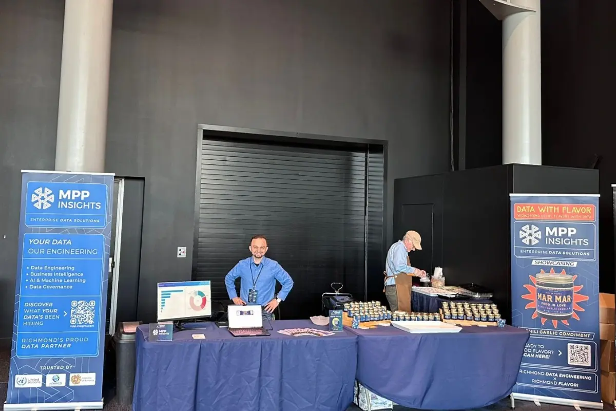 MPP Insights booth at RVA Tech Data & AI Summit showcasing Data with Flavor campaign with co-branded Mar Mar jars and team members