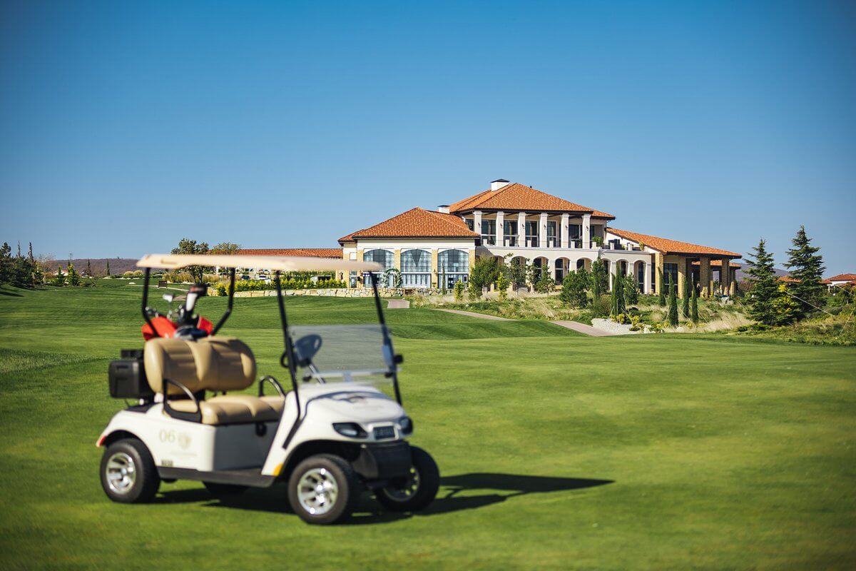 Expansive green golf course landscape under bright sky