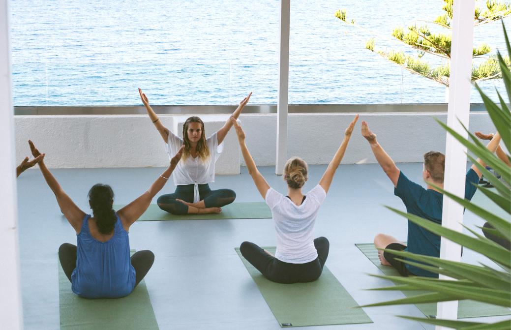 a group of people doing yoga at Karma Spa, Yoga and Wellbeing Jimbaran