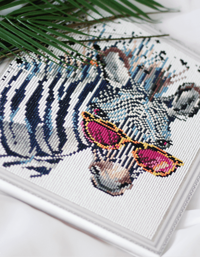 Diamond painting zebra with pink sunglasses on the white background