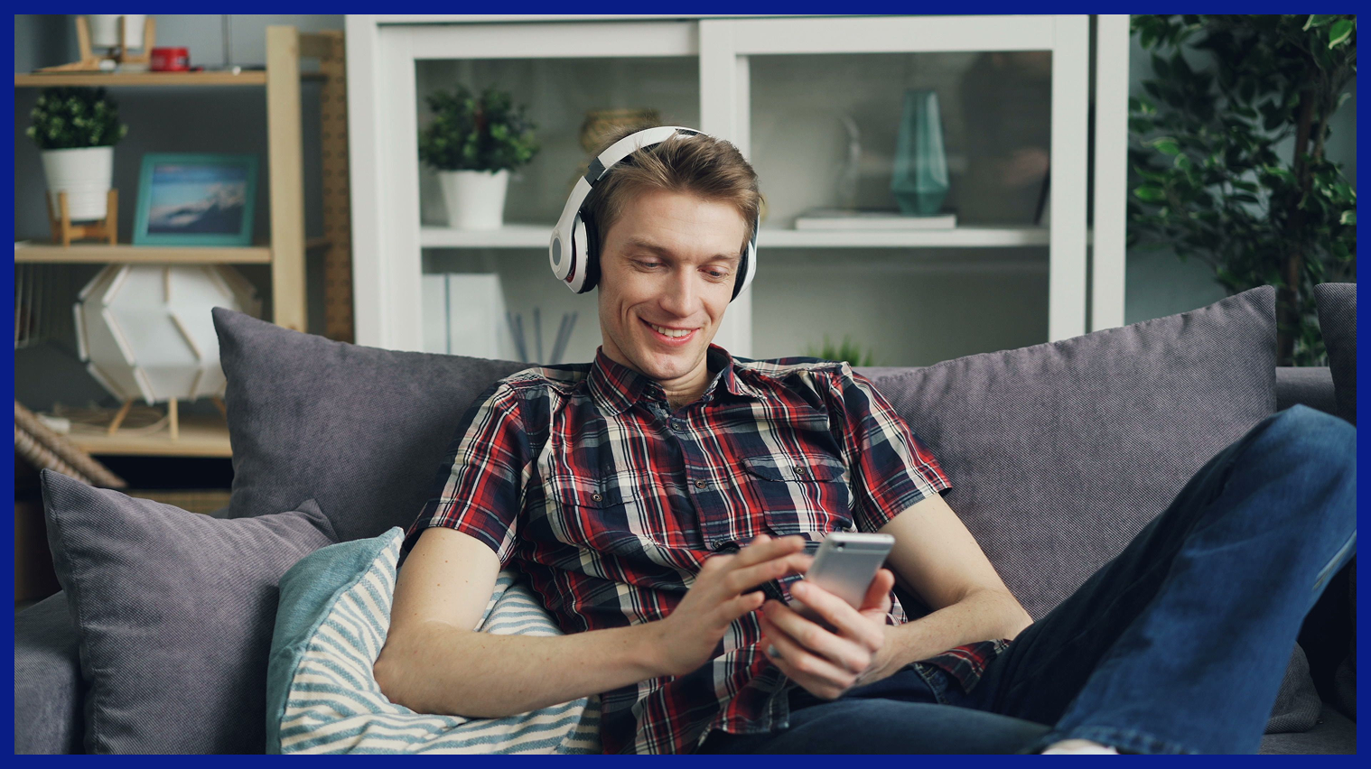 Man using a smartphone while wearing headphones, illustrating subscription management on One2Fan