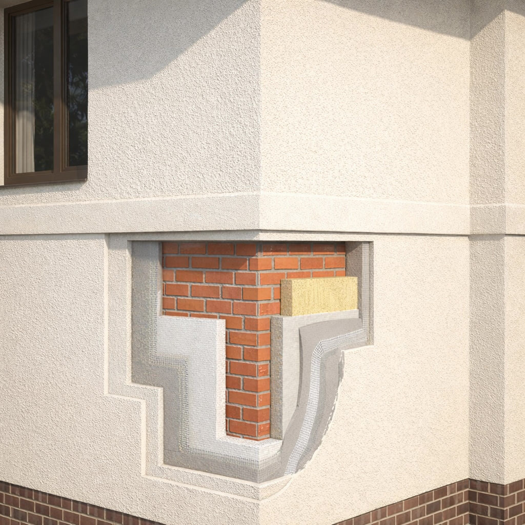 Разрез мокрого фасада на углу дома. Видны слои фасадной системы: кирпичное основание, утеплитель, базовый армирующий слой и декоративная штукатурка.