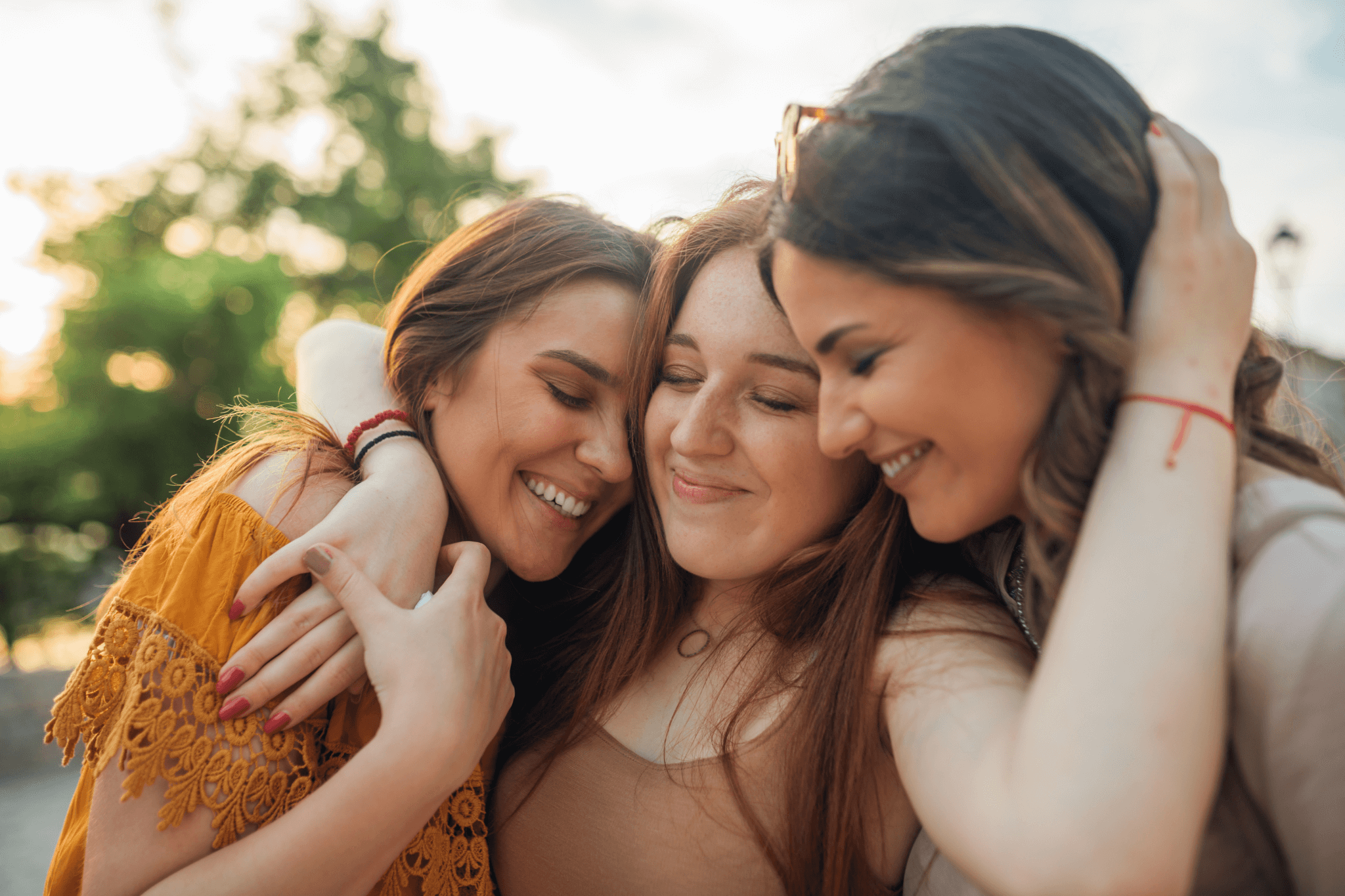 Drei Freundinnen umarmen sich erleichtert und glücklich