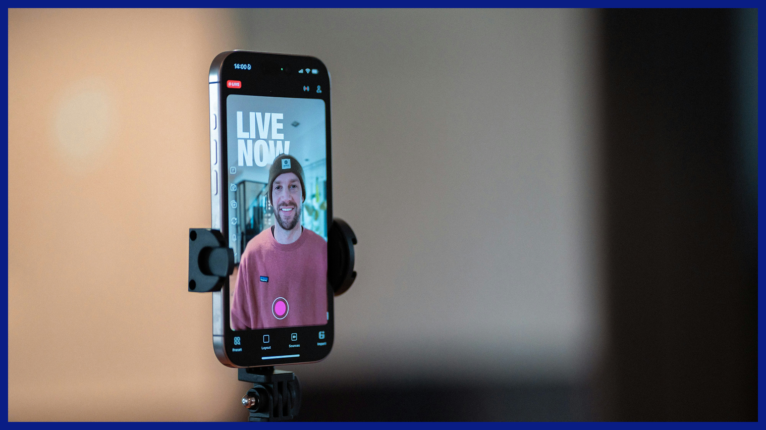 Smartphone on a tripod recording a male content creator during a live video