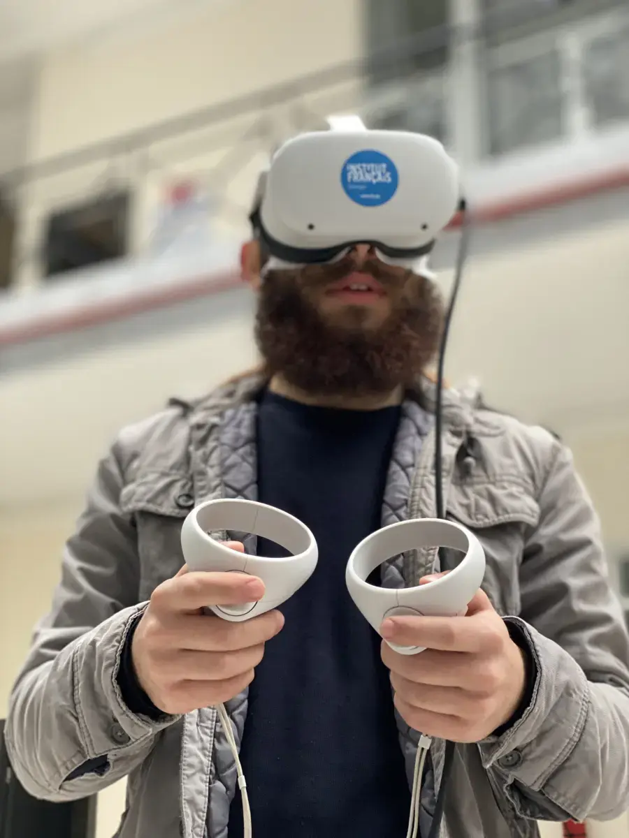 Visitor using VR controllers during an interactive experience