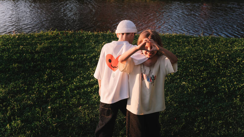 Boy walking away, heart on shirt