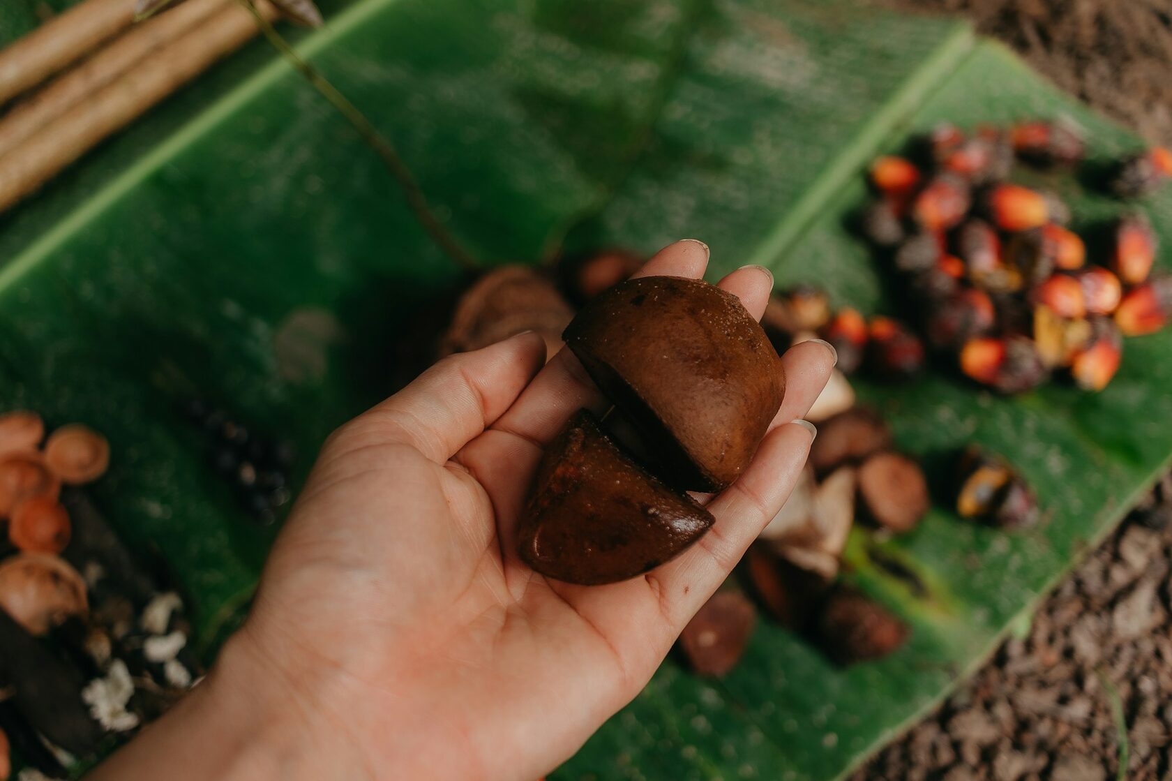 Therapist's hands working with warm tropical oils during a Good Spa massage treatment